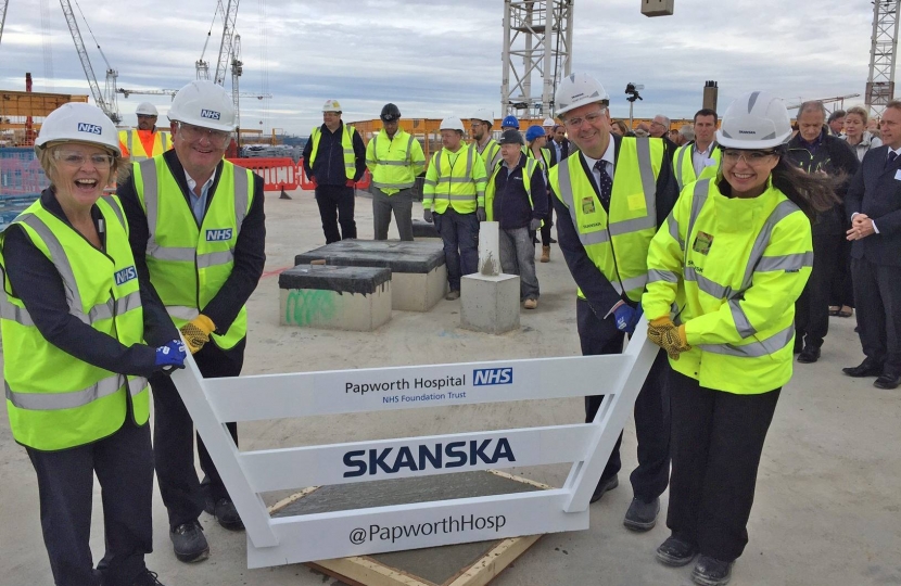 Heidi Allen MP, right, helping to top out the new Papworth Hospital building on the Addenbrooke's campus, Cambridge.  With her are Claire Tripp, Interim Chief Executive at Papworth Hospital, Prof John Wallwork and Terry Elphick of the main contractor, Skanska.