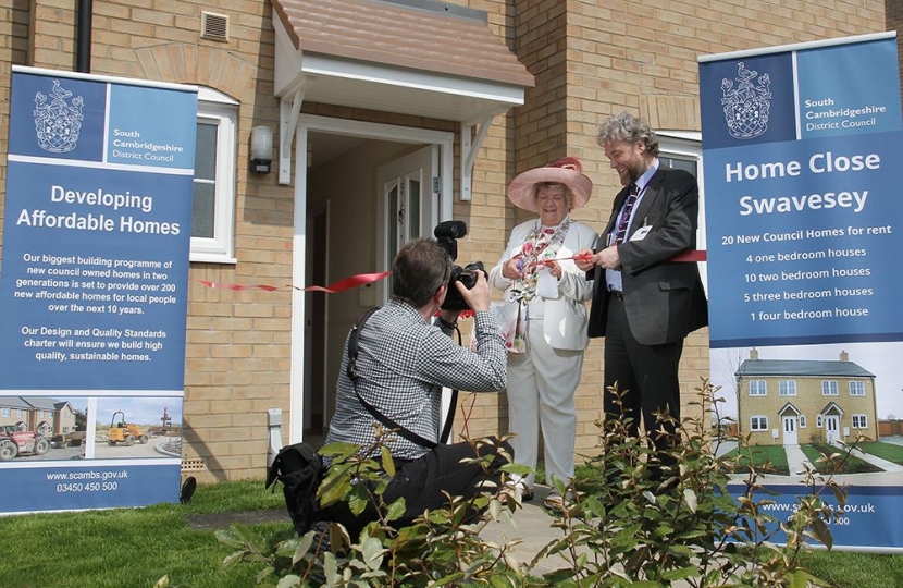 Councillor Sue Ellington, at the time Chairman of SCDC, and Stephen Hills, SCDC's Director of Housing, cutting the ribbon in May 2016 in front of the new, four bedroomed council house in Swavesey.