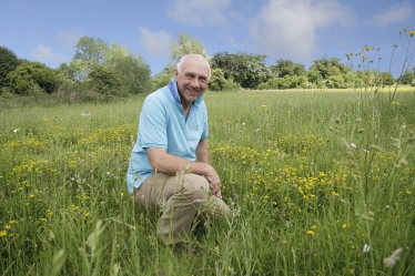 Tim Scott is the new Environmental Champion for South Cambridgeshire – seen here amongst wild flowers on Countryside Restoration Trust land in Barton.